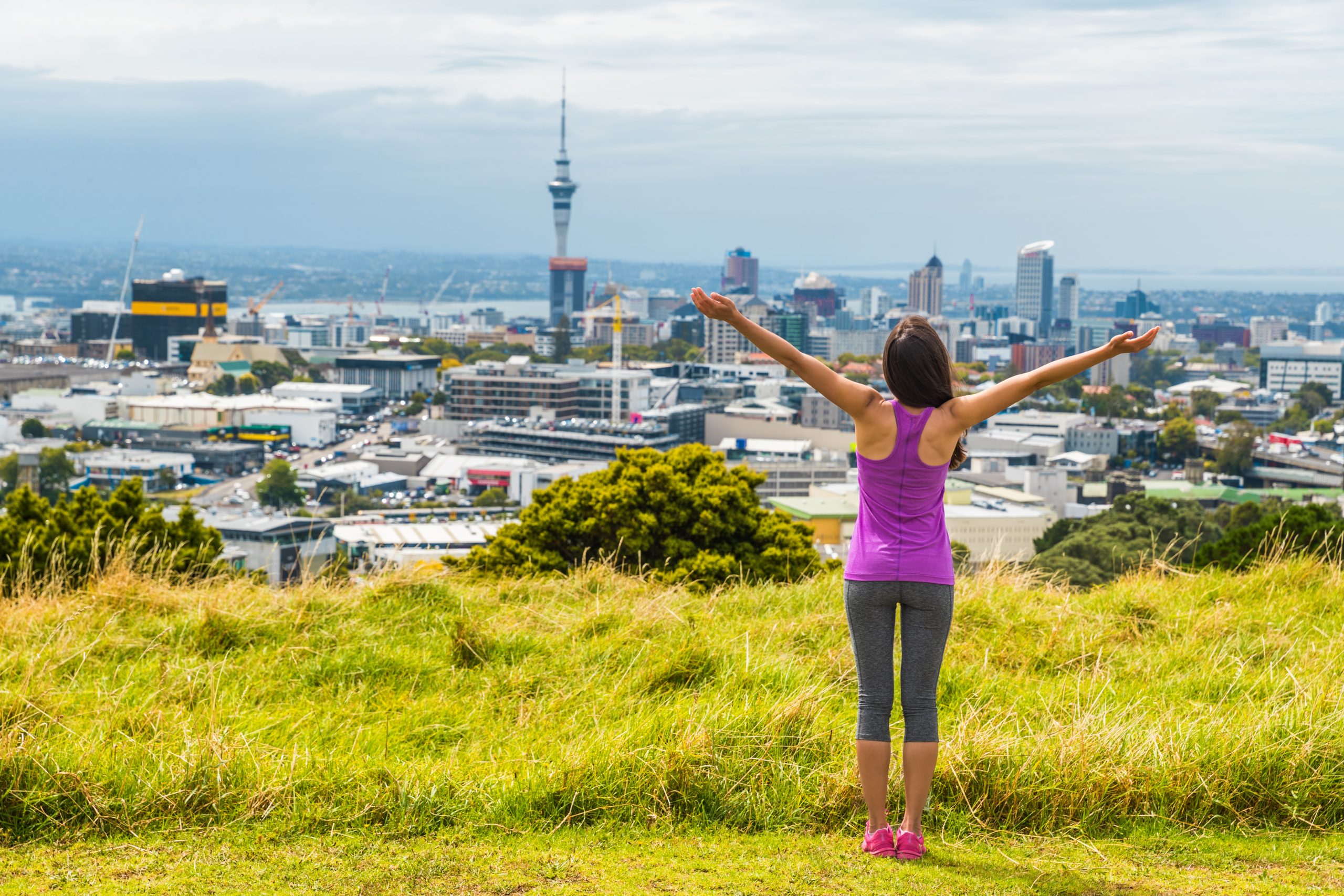 LAdy standing with view of Auckland city