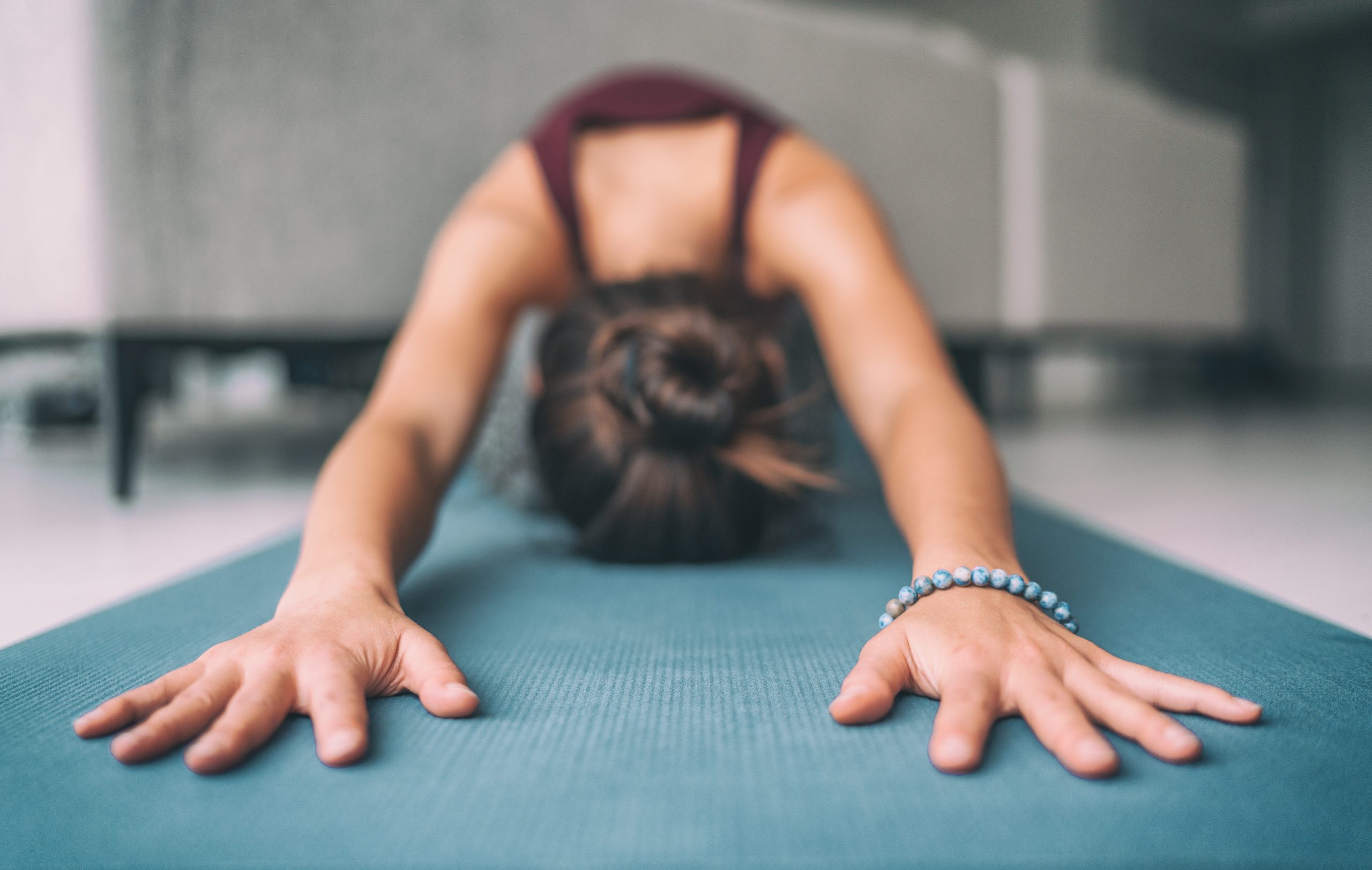 Lady doing yoga pose on yoga mat