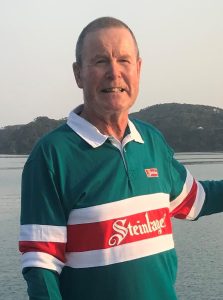 Kevin Miller with Steinlager jumper on boat